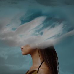 Woman's head covered by clouds.