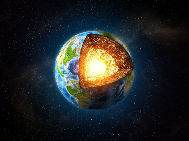 rendering of planet Earth in space with a cross section removed, showing the mantle and core