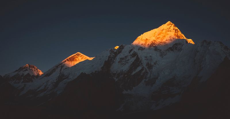 Evening sun paints the peaks of the Himalayan Mountain Range in Asia. 