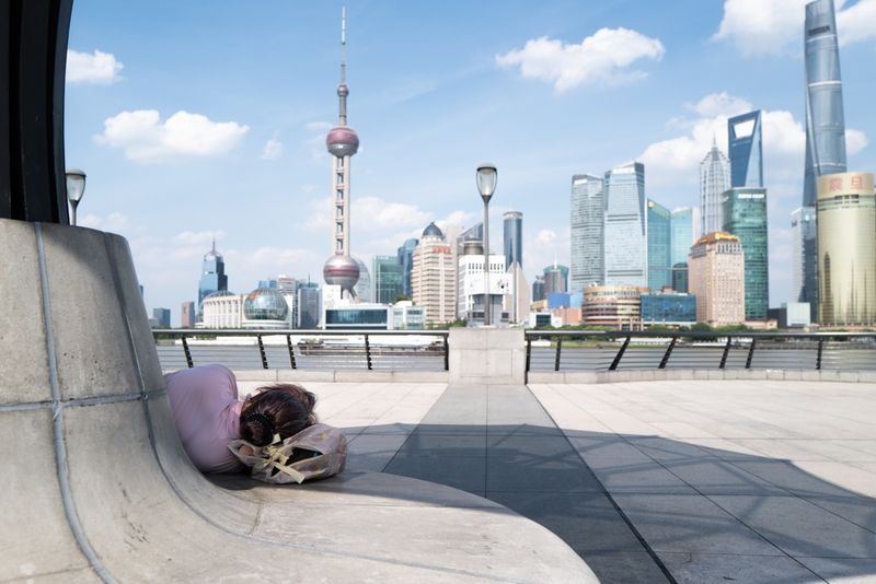 A tourist rests their weary little head on the Shanghai waterfront during China's heatwave on July 22, 2022.