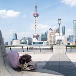 A tourist rests their weary little head on the Shanghai waterfront during China's heatwave on July 22, 2022.