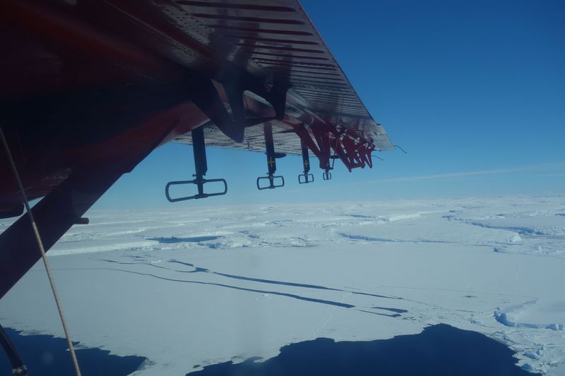 British Antarctic Survey Twin Otter aircraft flies over Thwaites Glacier with instrumentation attached to the wing ()