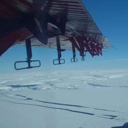 British Antarctic Survey Twin Otter aircraft flies over Thwaites Glacier with instrumentation attached to the wing ()