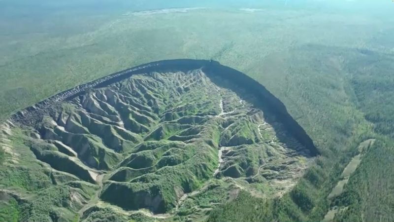 View of the Batagaika crater, as permafrost thaws causing a megaslump in the eroding landscape, in Russia's Sakha Republic in this still image from video taken July 11 or 12, 2023. 