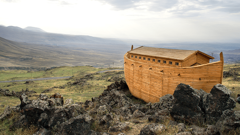 A large Ark sits on top of a mountain, with no sea to be seen.