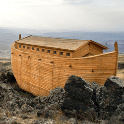 A large Ark sits on top of a mountain, with no sea to be seen.