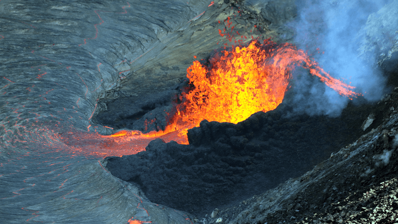 Crater of a volcano with lava coming out of the top