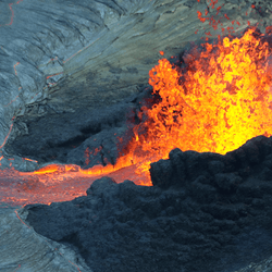 Crater of a volcano with lava coming out of the top