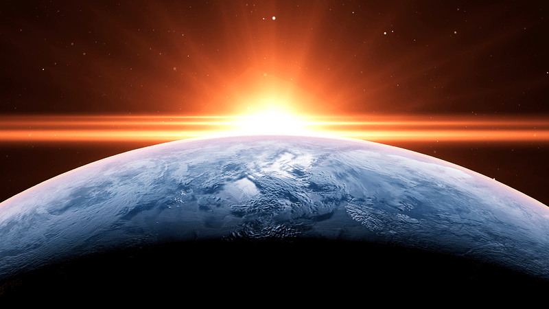 The Sun rising above the Earth.