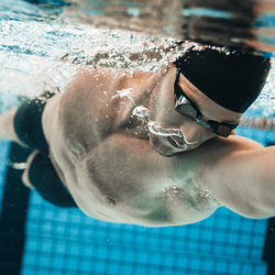 A swimmer doing front crawl, from below the water.